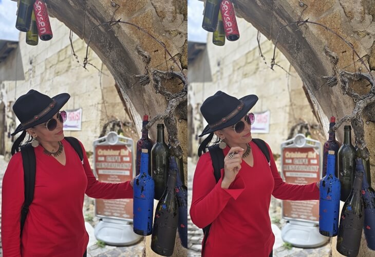 Ortahisar’da bağcılık kültürünü yansıtan süslenmiş şarap şişelerini inceleyen bir gezgin; Kapadokya sokak atmosferi